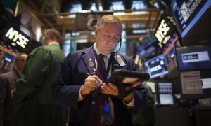  A trader works on the floor of the New York Stock Exchange during the opening bell in New York, November 27, 2013. Credit: Reuters/Carlo Allegri 