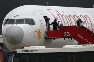 Police officers help passengers disembark from the hijacked Ethiopian Airlines flight ET 702 at Cointrin Airport in Geneva February 17, 2014. CREDIT: REUTERS/DENIS BALIBOUSE