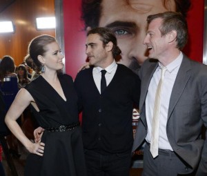 Cast members Amy Adams and Joaquin Phoenix stand next to writer/director Spike Jonze at the film premiere of ''Her'' at the Directors Guild of America in Hollywood December 12, 2013. CREDIT: REUTERS/KEVORK DJANSEZIAN