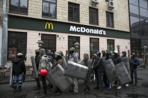 Anti-Yanukovich demonstrators stand in front of a McDonald's, which has been turned into an anti-Yanukovich activists headquarters, in Kiev February 23, 2014. CREDIT: REUTERS/BAZ RATNER