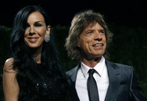 Designer L'Wren Scott and rock musician Mick Jagger pose as they arrive at the 2009 Vanity Fair Oscar Party in West Hollywood
