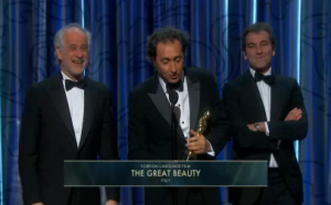 Director Paolo Sorrentino accepts the award for the Italian drama "The Great Beauty" which won the Oscars for best foreign language  film. (Courtesy Reuters.  Photo grabbed from Reuters video)