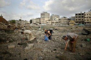 Palestinians search for scattered body parts amongst the rubble of Tayseer Al-Batsh's family house, which police said was destroyed in an Israeli air strike in Gaza City July 13, 2014. Credit: Reuters/Mohammed Salem