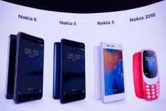 New phone models by Nokia are displayed on a screen during the presentation of the new models "Nokia 6", "Nokia 5", "Nokia 3" and "Nokia 3310" during a press conference on February 26, 2017 in Barcelona on the eve of the start of the Mobile World Congress. Phone makers will seek to seduce new buyers with even smarter Internet-connected watches and other wireless gadgets as they wrestle for dominance at the world's biggest mobile fair starting tomorrow.  / AFP PHOTO / Josep Lago
