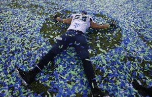 Seattle Seahawks Malcom Smith makes an angel in the confetti after his team defeated the Denver Bronocs in the NFL Super Bowl XLVIII football game in East Rutherford, New Jersey, February 2, 2014. Credit: REUTERS/Shannon Stapleton