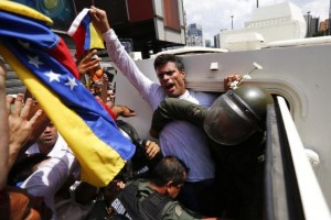 Venezuelan opposition leader Leopoldo Lopez gets into a National Guard armored vehicle in Caracas