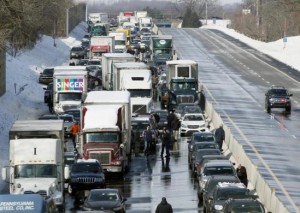Drivers stand outside of their cars as traffic is backed up after a multi-car and truck accident during the morning commute, shutting down the major thoroughfare near the Bensalem interchange in Pennsylvania, February 14, 2014. REUTERS/Tom Mihalek