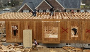 Workers build a new house in Alexandria, Virginia February 16, 2012. REUTERS/Kevin Lamarque