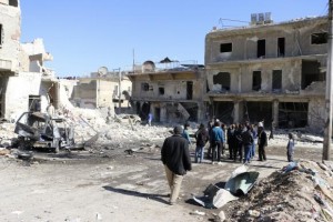  People gather at a site hit by what activists said was a barrel bomb dropped by forces loyal to Syria's President Bashar al-Assad in Haydariye district in Aleppo February 12, 2014. Credit: Reuters/Hosam Katan 