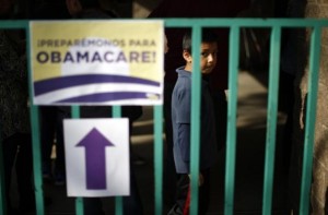 A boy waits in line at a health insurance enrollment event in Cudahy, California