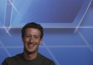 Facebook Chief Executive Officer Mark Zuckerberg smiles in the stage before delivering a keynote speech during the Mobile World Congress in Barcelona February 24, 2014. Credit: Reuters/Albert Gea