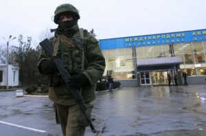 An armed man patrols at the airport in Simferopol, Crimea February 28, 2014. A group of armed men in military uniforms have seized the main regional airport in Simferopol, Crimea, Interfax news agency said early on Friday. REUTERS/David Mdzinarishvili