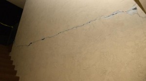 A large crack is seen in a wall of an apartment complex after a magnitude 5.1 earthquake in Fullerton, California March 29, 2014. CREDIT: REUTERS/GENE BLEVINS