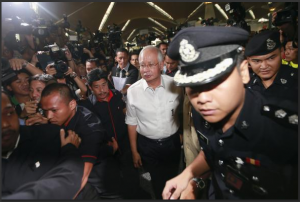 Malaysia's Prime Minister Najib Razak (C) arrives at the holding area for family and friends of passengers aboard missing Malaysia Airlines flight MH370, at Kuala Lumpur International Airport in Sepang March 8, 2014. REUTERS/Samsul Said