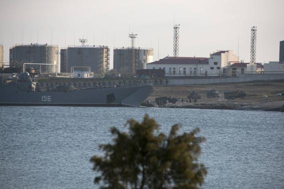 Trucks drive out of Russian landing craft Yamal 156 near the Crimean port of Sevastopol March 14, 2014. CREDIT: REUTERS/STRINGER