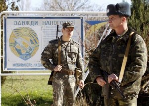 Ukrainian servicemen stand guard on the territory of their military unit located in the village of Lyubimovka near a local airfield, southwest of Simferopol, Crimea's capital March 3, 2014. REUTERS/Vasily Fedosenko