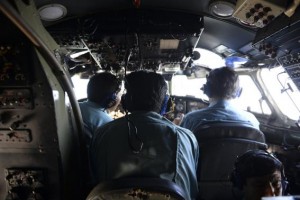 Vietnamese Air Force officers sit in the cockpit of a search and rescue aircraft as they fly over the search area for a missing Malaysia Airlines plane, 250 km from Vietnam and 190 km from Malaysia, March 9, 2014. REUTERS/Stringer