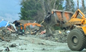 Crews beging clearing muddy rubble in Washington state as hopes for finding additional missing residents dwindles.  At least 176 are reported missing in the deadly landslide.  (Courtesy Reuters.  Photo grabbed from Reuters video)