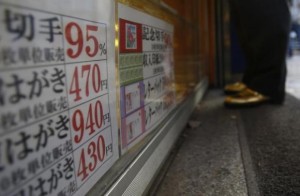 A man looks at the prices of tickets at a ticket shop in Tokyo