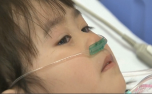 Six year-old Kwon Ji-yeon, rescued from the sunken ferry in South Korea, sheds a tear while being treated at a hospital.  Her parents and brother are still missing.  (Photo grabbed from Reuters video)