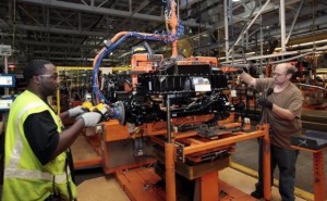 Ford Assembly workers install a battery onto the chassis of a Ford Focus Electric vehicle at the Michigan Assembly Plant in Wayne