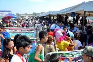 People lined up for the "goodwill bags" each containing three kilos of rice, three noodle packs and three cans of sardines.  About 150,000 goodwill bags were distributed at the Iglesia Ni Cristo's commemoration of the first year anniversary of "Kabayan Ko, Kapatid Ko" held at the Mall of Asia grounds on April 26, 2014.