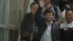 Manny Pacquiao waves at his fans upon arrival at the Ninoy Aquino International Airport's Centennial terminal on Friday, April 18.  (Eagle News Service)