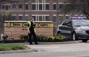 An Overland Park Kansas police officer guards the entrance to the scene of a shooting at the Jewish Community Center of Greater Kansas City in Overland Park, Kansas April 13, 2014. CREDIT: REUTERS/DAVE KAUP