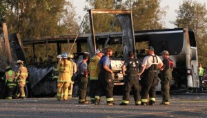 Rescue workers, police and firefighters survey the scene where a truck and a tour bus collided on Interstate 5 near Highway 32 near Orland, California, April 10, 2014. MANDATORY CREDIT CREDIT: REUTERS/GREG BARNETTE/RECORD SEARCHLIGHT