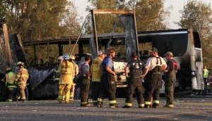 Rescue workers, police and firefighters survey the scene where a truck and a tour bus collided on Interstate 5 near Highway 32 near Orland, California, April 10, 2014. MANDATORY CREDIT  CREDIT: REUTERS/GREG BARNETTE/RECORD SEARCHLIGHT