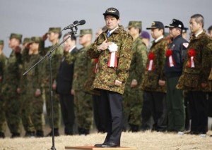 Japan's Defence Minister Itsunori Onodera (C) reviews troops from the Japanese Ground Self-Defense Force 1st Airborne Brigade during an annual new year military exercise at Narashino exercise field in Funabashi, east of Tokyo January 12, 2014. Some 300 soldiers including Japan's elite paratroops and 20 aircraft conducted an island defense display based on a scenario of counter the military threat of invasion on Japanese territory islands by a hostile country. REUTERS/Issei Kato 