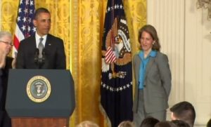 President Barack Obama takes stage at White House along with his budget director Sylvia Mathews Burwell who will replace Kathleen Sebelius as U.S. Health Secretary (Photo grabbed from Reuters video)