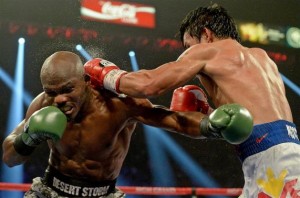 Apr 12, 2014; Las Vegas, NV, USA; Timothy Bradley Jr.(brown gloves) and Manny Pacquiao (red gloves) during their WBO World Welterweight Championship fight at MGM Grand Garden Arena. Manny Pacquiao won by decision. Mandatory Credit: Jayne Kamin-Oncea-USA TODAY Sports