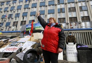 A pro-Russian protester gestures at a barricade in front of the seized office of the SBU state security service in Luhansk, in eastern Ukraine April 14, 2014.  CREDIT: REUTERS/SHAMIL ZHUMATOV