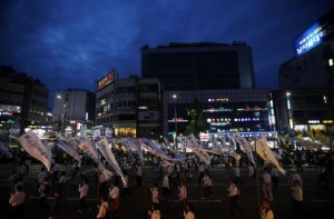 Participants holding funeral streamers bearing messages for victims of the capsized passenger ship Sewol, march during a lotus lantern parade to celebrate the upcoming birthday of Buddha and to commemorate the victims, in Seoul April 26, 2014. CREDIT: REUTERS/KIM HONG-JI