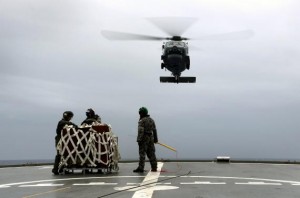 A S-70B-2 Seahawk (Tiger 75) helicopter makes an approach to the flight deck of Australian Navy ship HMAS Toowoomba to pick up supplies during a vertical replenishment at sea with HMAS Success as they continue to search for the missing Malaysian Airlines flight MH370 in this picture released by the Australian Defence Force April 6, 2014. International search planes and ships are heading to an area where a Chinese ship twice heard what could be signals from missing MH370's black box locators, Australian search authorities said on Sunday. Aircrews from seven countries have been flying dozens of missions from Perth deep into the southern Indian Ocean looking for debris from the jet and have been joined by ships fitted with sophisticated equipment designed to pick up the locators on the black box voice and data recorders.  REUTERS/Australian Defence Force/Handout via Reuters