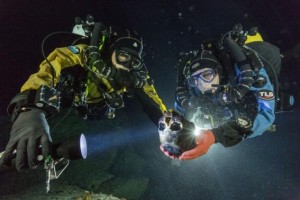 Handout of divers Nava and Bird transporting a skull to an underwater turntable for photographing in an underwater cave in Mexico's Yucatan Peninsula