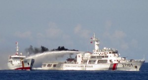 A Chinese ship (R) uses water cannon on a Vietnamese Sea Guard ship on the South China Sea near the Paracels islands, in this handout photo taken on May 3, 2014 and released by the Vietnamese Marine Guard on May 8, 2014.  REUTERS/Vietnam Marine Guard/Handout via Reuters