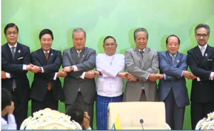 ASEAN foreign ministers do the traditional ASEAN handshake as they prepare for a photo during a conference ahead of the 24th ASEAN summit.  (Photo grabbed from Reuters video)