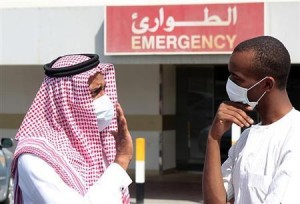 Reuters File photo.  Men wearing surgical masks as a precautionary measure against the novel coronavirus, speak at a hospital in Khobar city.