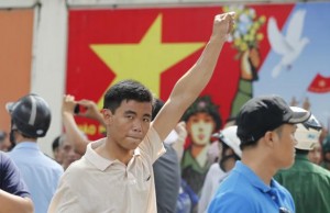 A protester gestures as he marches during an anti-China protest in Vietnam's southern Ho Chi Minh city May 18, 2014. Vietnam flooded major cities with police to avert anti-China protests on Sunday in the wake of rare and deadly rioting in industrial parks that deepened a tense standoff with Beijing over sovereignty in the South China Sea. Several arrests were made in the capital Hanoi and commercial hub Ho Chi Minh City within minutes of groups trying to start protests, according to witnesses, as Vietnam's communist rulers stuck to their vow to thwart any repeat of last week's violence in three provinces in the south and centre. REUTERS/Peter Ng