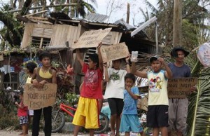 File photo of schoolchildren holding signs asking for help and food along the highway, after Typhoon Haiyan hit Tabogon town in Cebu Province, central Philippines November 11, 2013. REUTERS/Charlie Saceda