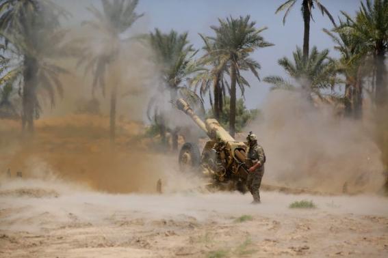 Iraqi security forces fire artillery during clashes with Sunni militant group Islamic State of Iraq and the Levant (ISIL) in Jurf al-Sakhar June 14, 2014. Picture taken June 14, 2014. CREDIT: REUTERS/ALAA AL-MARJANI
