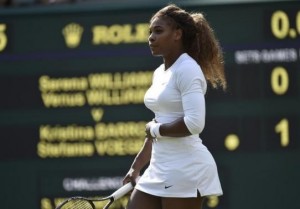  Serena Williams of the U.S. holds her stomach before retiring from her women's doubles tennis match with Venus Williams of the U.S. against Kristina Barrois of Germany and Stefanie Voegele of Switzerland at the Wimbledon Tennis Championships, in London July 1, 2014. Credit: Reuters/Toby Melville
