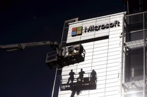 Workers install the logo of U.S. technology giant Microsoft on the wall of Nokia's former headquarters in Espoo April 26, 2014. Credit: Reuters/Mikko Stig/Lehtikuva
