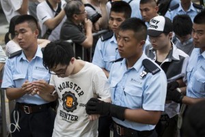 Protesters are taken away by police officers after staying overnight at Hong Kong's financial Central district July 2, 2014. Credit: Reuters/Tyrone Siu