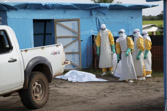  Health workers, wearing head-to-toe protective gear, prepare for work, outside an isolation unit in Foya District, Lofa County, Liberia in this July 2014 UNICEF handout photo. Credit: Reuters/Ahmed Jallanzo/UNICEF/Handout via Reuters