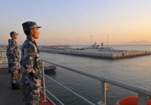 File photo. Chinese naval soldiers stand guard on China's first aircraft carrier Liaoning, as it travels towards a military base in Sanya, Hainan province, in this undated picture made available on November 30, 2013. REUTERS/Stringer