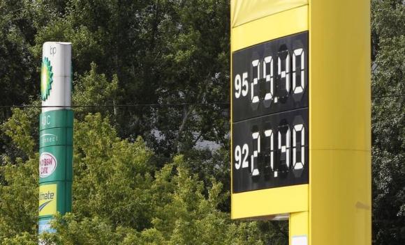  A gasoline station board displaying fuel prices stands beside a sign owned by a BP petrol station (L) in Moscow July 24, 2012. Credit: Reuters/Maxim Shemetov 