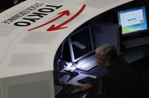 An employee of the Tokyo Stock Exchange (TSE) looks at a monitor at the bourse at the TSE in Tokyo March 3, 2014. Credit: Reuters/Issei Kato